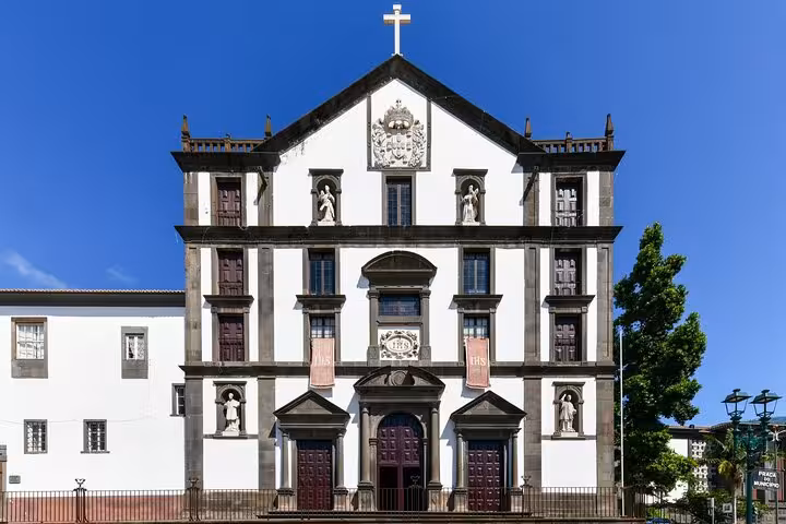 Historic church facade under clear skies in Funchal, a highlight of the private two-hour city walking tour.
