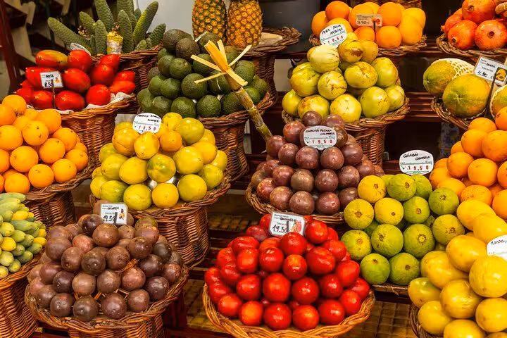 Colorful display of exotic fruits at Funchal market, showcasing local flavors on a private city walking tour.