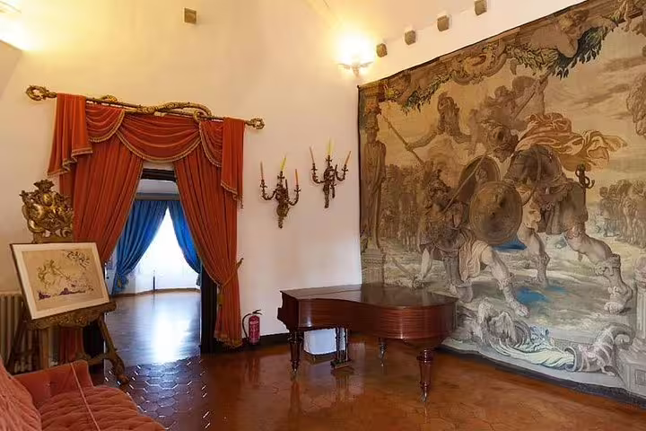 Luxurious interior of Gala Castle featuring ornate drapery and grand tapestry, highlights of an exclusive tour.