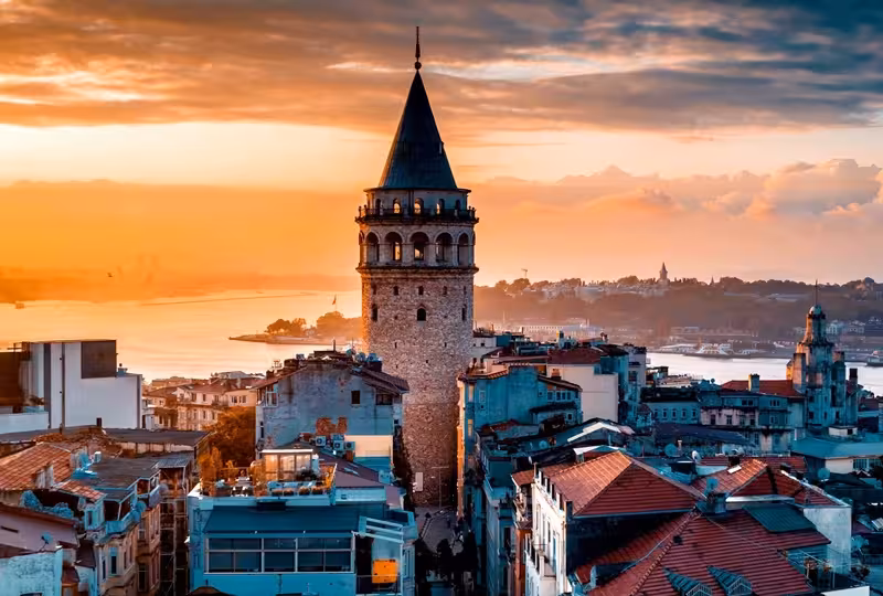 Galata Tower at sunset over Istanbul rooftops, iconic stop on 9-day Turkey tour from Istanbul to Cappadocia