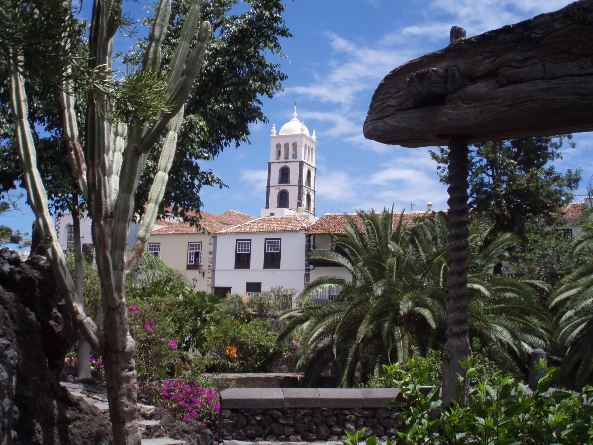 Historic church tower rising over lush gardens in Garachico, a highlight of the Masca Garachico Icod private excursion.