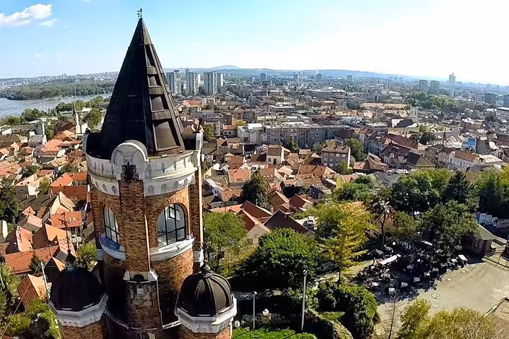 Aerial view of Gardos Tower overlooking Belgrade's scenic rooftops and skyline on a sunny day.