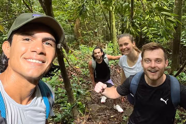Group of hikers enjoying the lush trail in Garganta do Céu, Pedra da Gávea, perfect for nature enthusiasts.