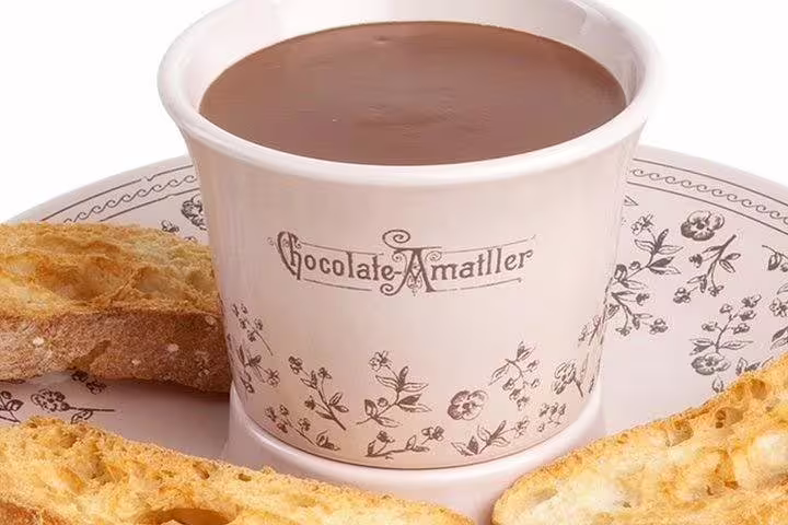 Indulge in rich, creamy hot chocolate from Chocolate Amatller, perfect for a Gaudi's Casa Batlló and La Pedrera tour break.