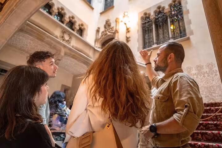 Guide explaining Gaudí Modernism details inside Casa Batlló on a Barcelona walking tour group visit