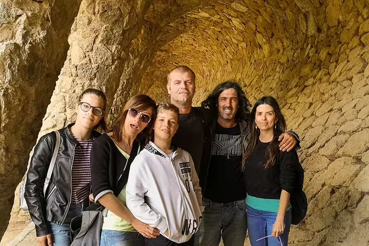 A group of tourists enjoying a visit to the iconic stone arches of Park Güell during a 2-day Gaudi and Montserrat tour.