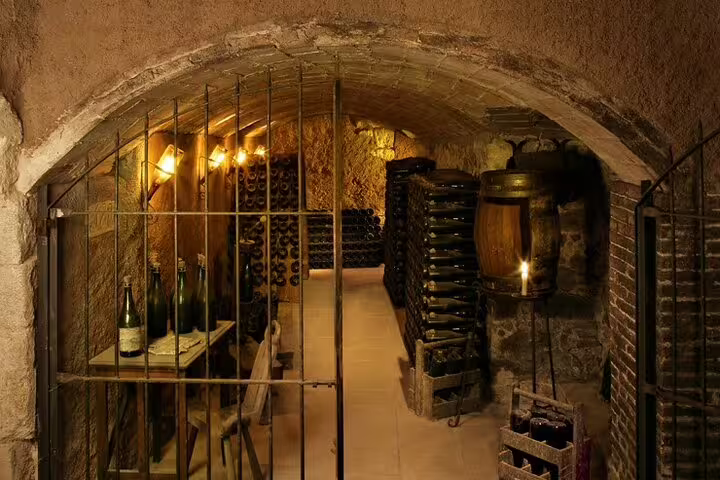 Explore a historic wine cellar during the Montserrat and winery tour, part of the 2-day Gaudi and Sagrada Familia experience.