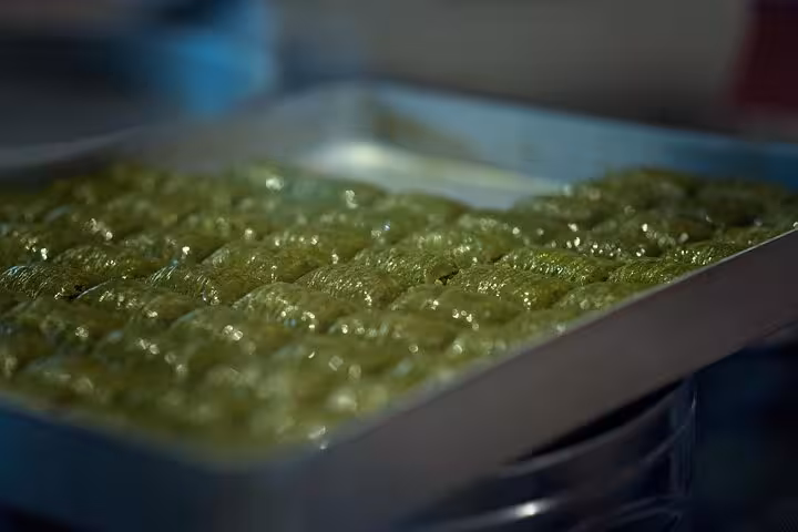 Fresh green pistachio baklava in syrup on a tray, a must-try stop on an all-inclusive private Gaziantep tour