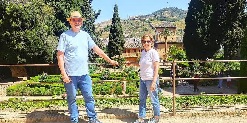 Travelers enjoying Generalife gardens views in Granada on Alhambra group tour with Costa del Sol pick-up