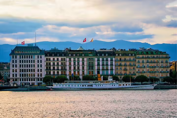 Lake Geneva skyline with historic hotels and moored boat, scenic highlight on a Geneva self-guided scavenger hunt