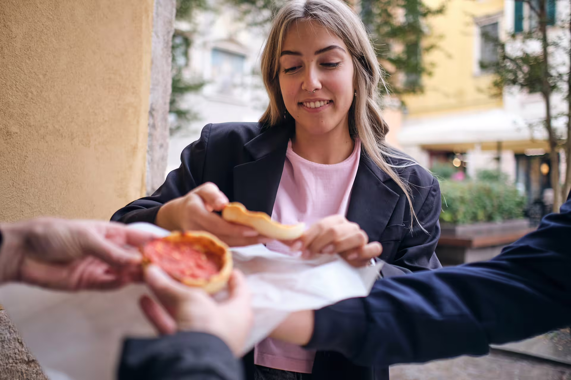 Traveler tasting focaccia with tomato during a 1.5-hour Genoa food guided tour in the historic center