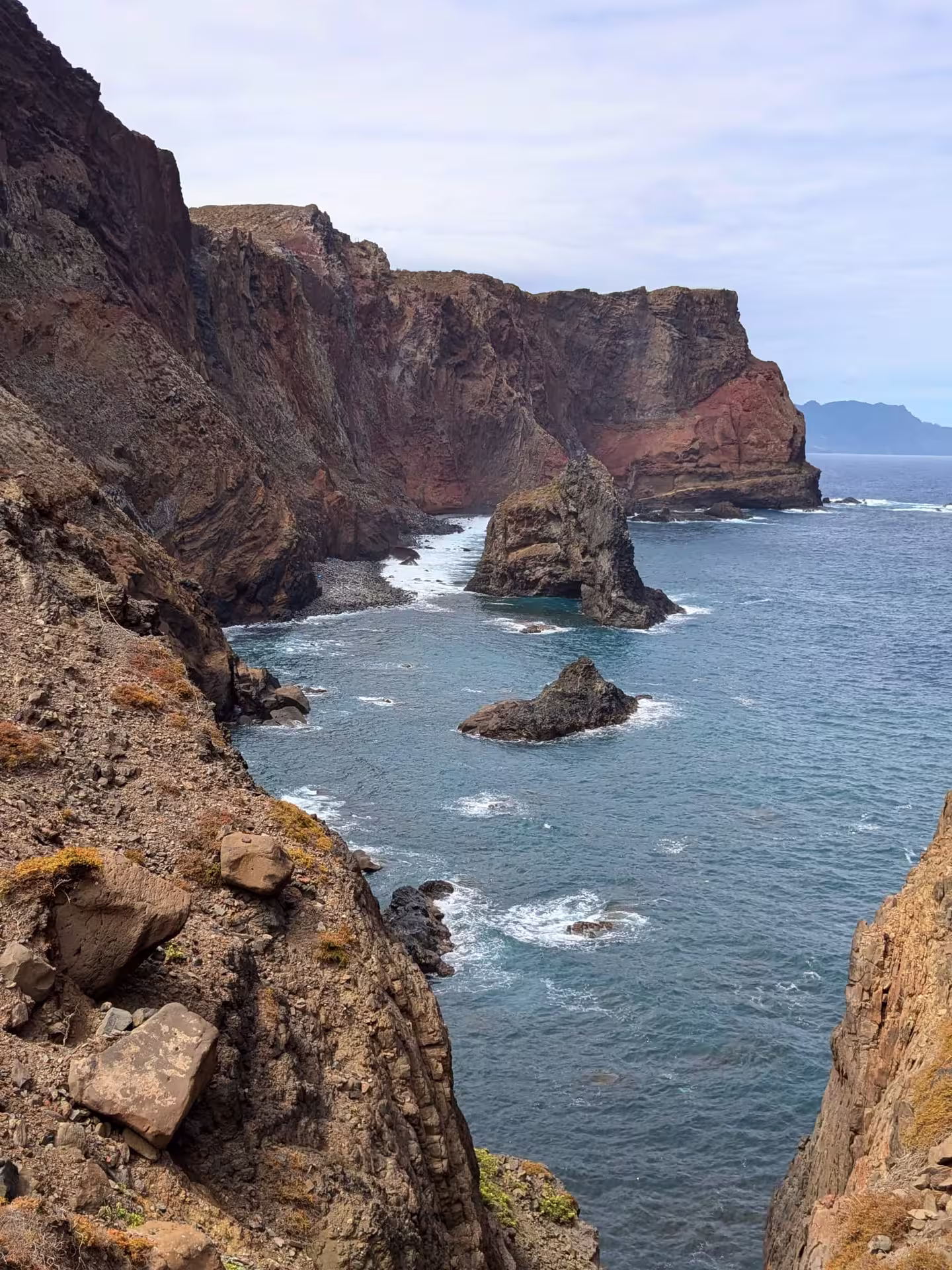 Dramatic cliffs and rock formations meet the ocean waves on The Geological Hike coastal adventure.
