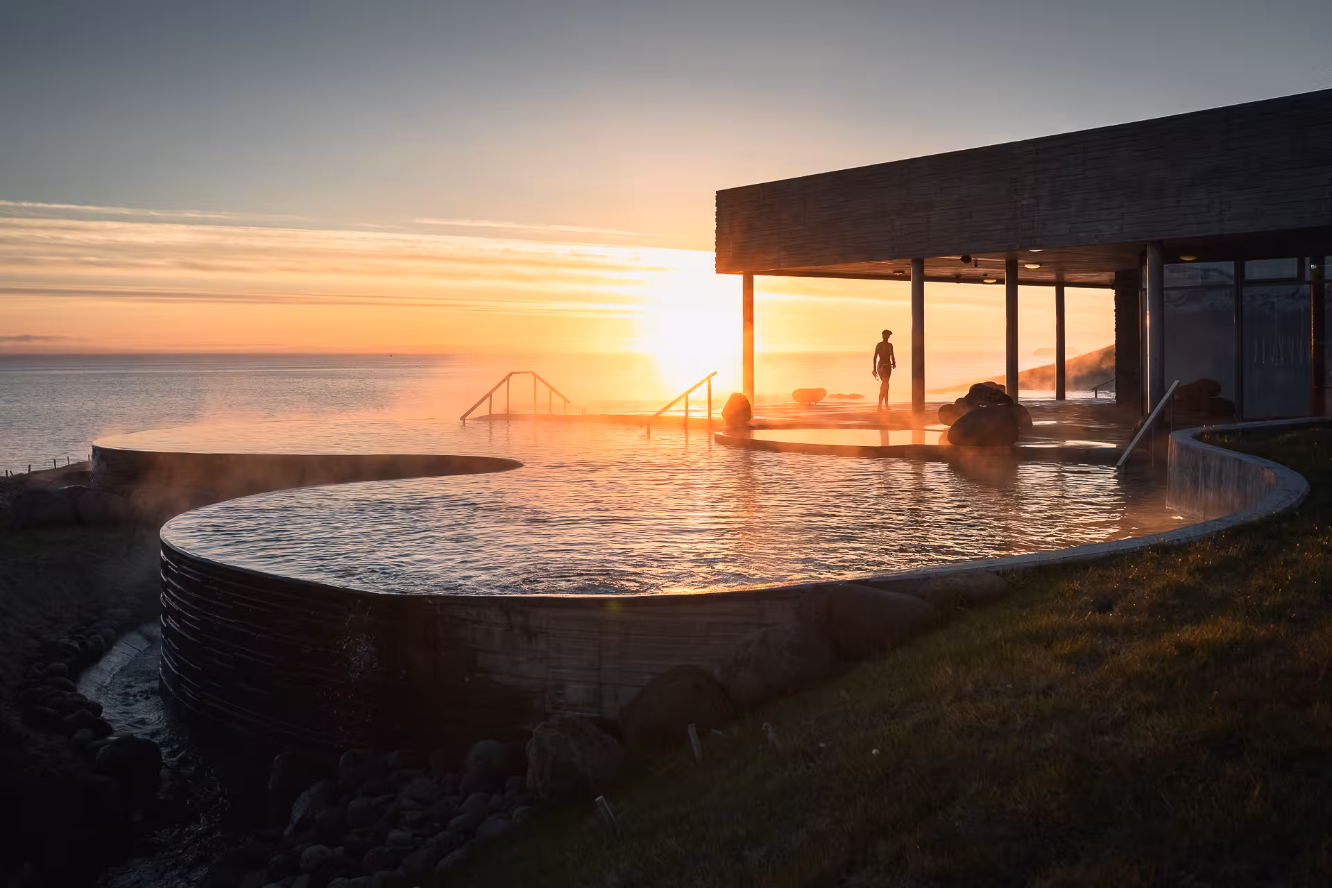 Sunset view from GeoSea Geothermal Baths in Iceland, showcasing serene waters and coastal beauty.