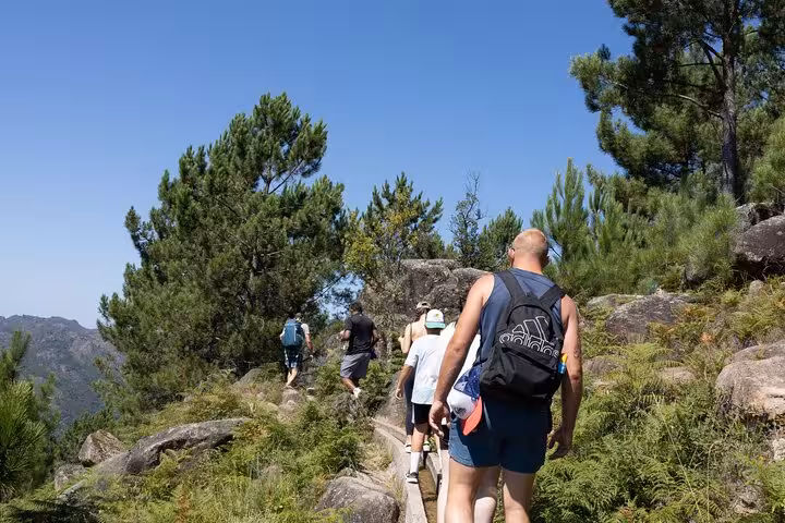 Group of hikers on a sunny trail in Geres National Park, showcasing the park's stunning landscapes and adventure potential.