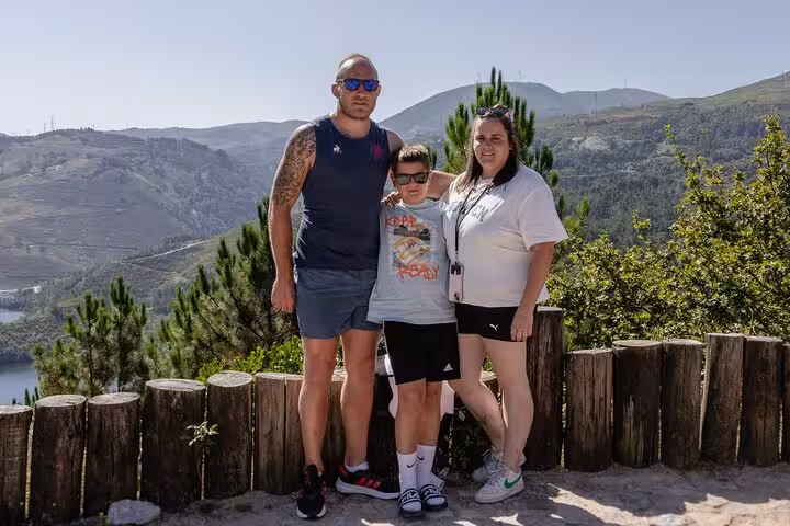 Family enjoys scenic view at Geres National Park, perfect for a lagoon hiking adventure with breathtaking landscapes.
