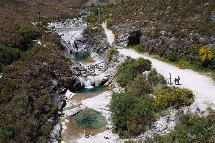 Scenic view of cascading waterfalls and natural lagoons in Geres National Park, perfect for hiking and swimming adventures.