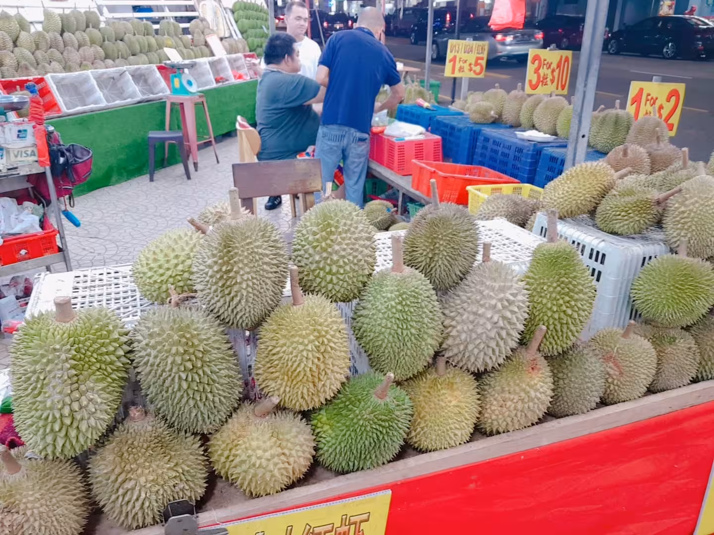 Bustling durian stall in Geylang, offering exotic fruits, a highlight on the Singapore Geylang walking tour.