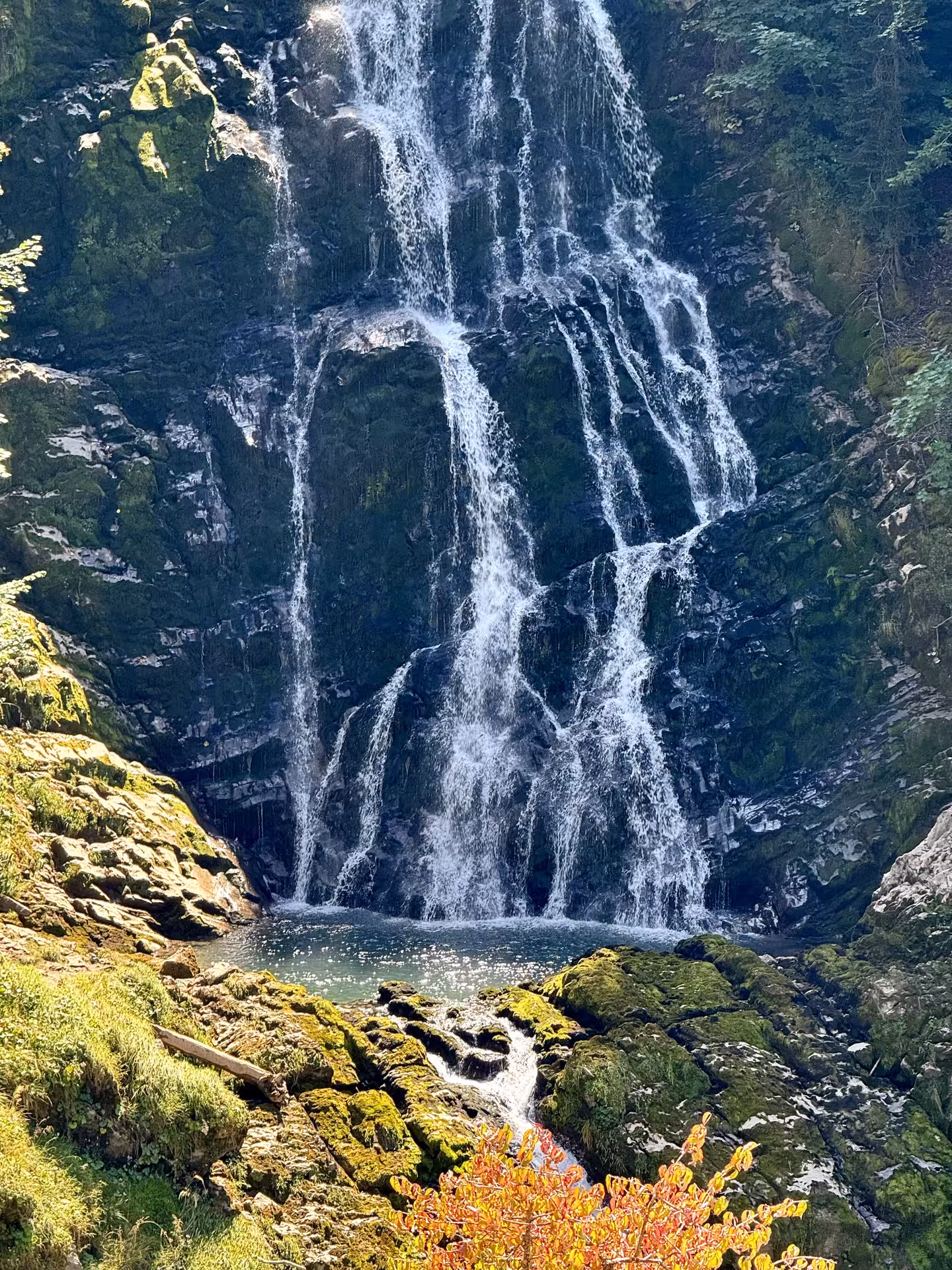 Giessbach Falls cascading over mossy rocks on the Iseltwald to Giessbach e-bike tour by Lake Brienz