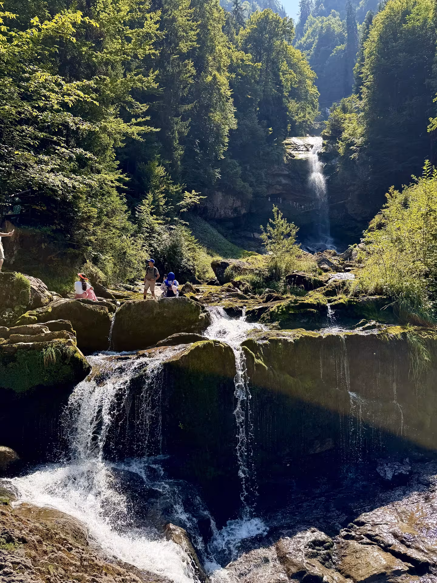 Giessbach Falls cascades in lush forest near Lake Brienz, scenic stop on Iseltwald & Giessbach e-bike tour