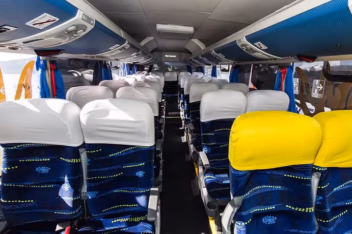 Spacious interior of a modern shuttle bus for exclusive transfers from GIG Airport to Rio de Janeiro hotels.