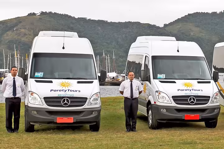 Two Paraty Tours shuttle vans with drivers at GIG Airport, offering exclusive Rio hotel transfers to the South area.