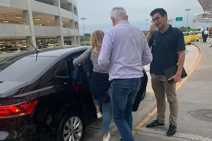 Passengers entering a private shuttle car at GIG Airport, ensuring smooth transfers to hotels in Rio's South area.