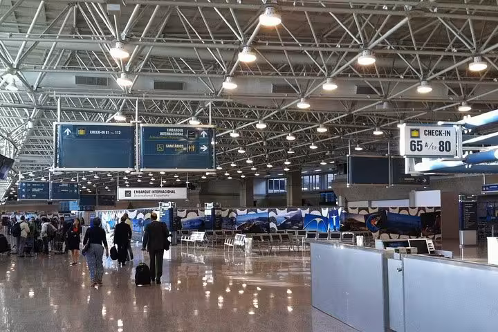 Passengers at GIG Airport terminal, preparing for exclusive shuttle service to Rio de Janeiro South area hotels.