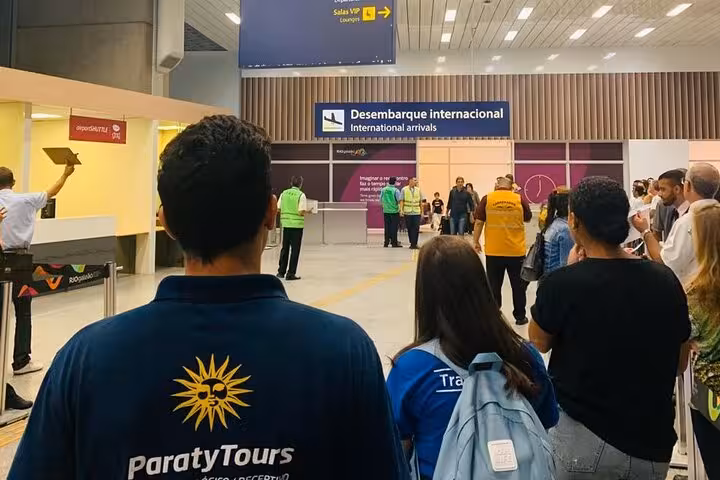 Travelers arriving at GIG Airport's international terminal, ready for private transfer to Barra da Tijuca hotels.