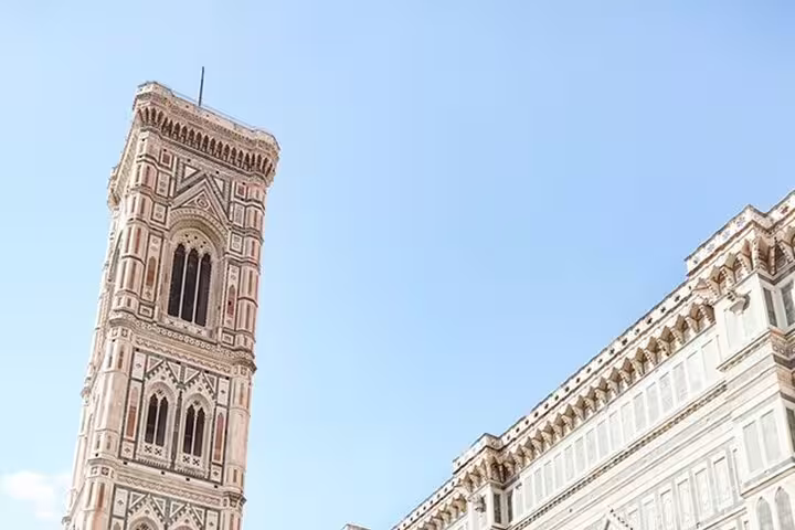 Giotto's Campanile and Florence Cathedral under a clear blue sky, ideal for exploring Florence's historical sites in a 4-hour tour.