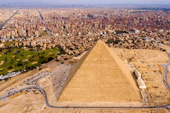 Aerial view of the Great Pyramid of Giza with Cairo skyline, skip-the-line entry ticket site access tour