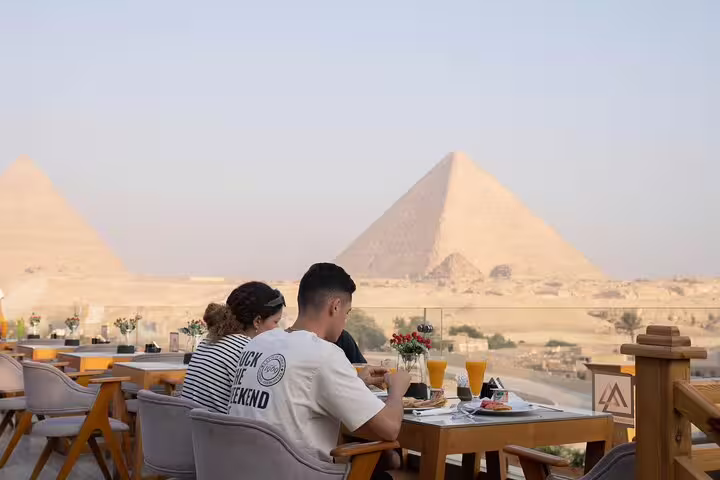 Dinner on Great Pyramid Inn rooftop terrace with panoramic Giza Pyramid view, perfect after Sound & Light show