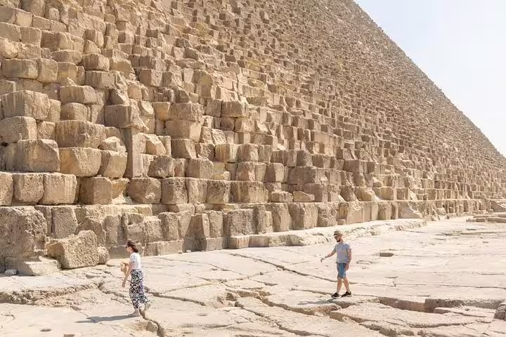 Close-up of Great Pyramid of Giza stone blocks with visitors on a private guided pyramids tour in Cairo