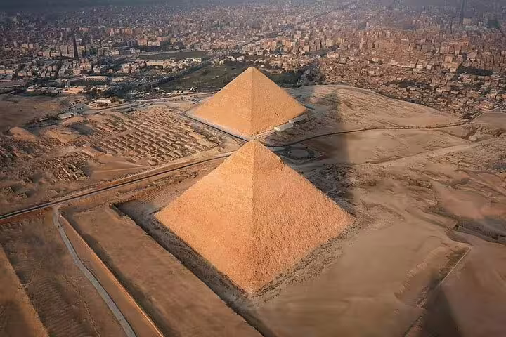 Aerial view of Giza Pyramids near Cairo skyline, luxury adventure tour to pyramids, Memphis and Sakkara