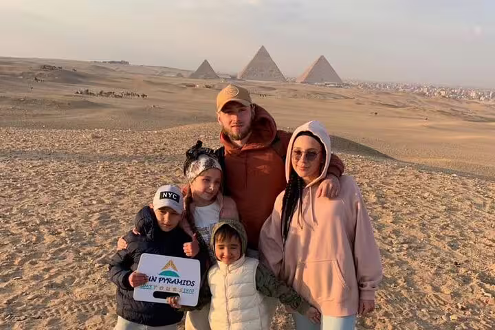 Family photo with Giza Pyramids backdrop on Cairo day tour from Luxor by plane, Egypt sightseeing