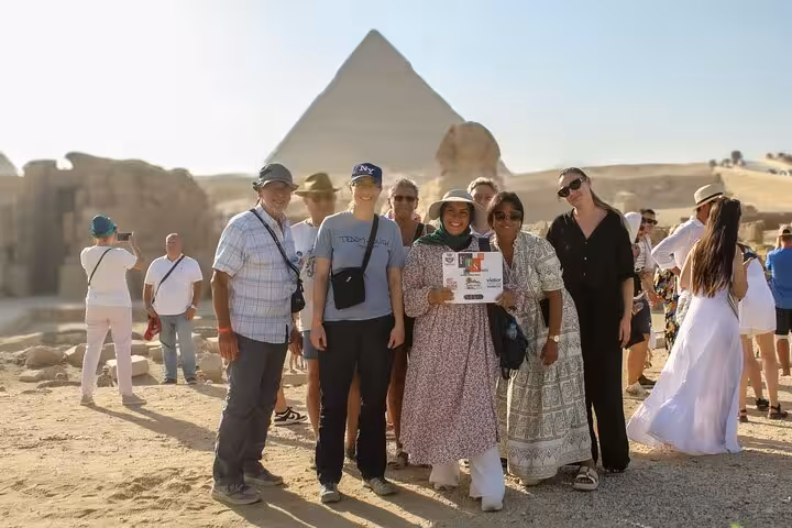 Small group photo at Giza Pyramids during Cairo full-day customized adventure tour with free camel ride