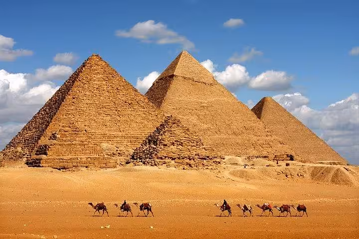 Giza Pyramids panorama with camel caravan in the desert, highlight of Hurghada to Cairo day tour