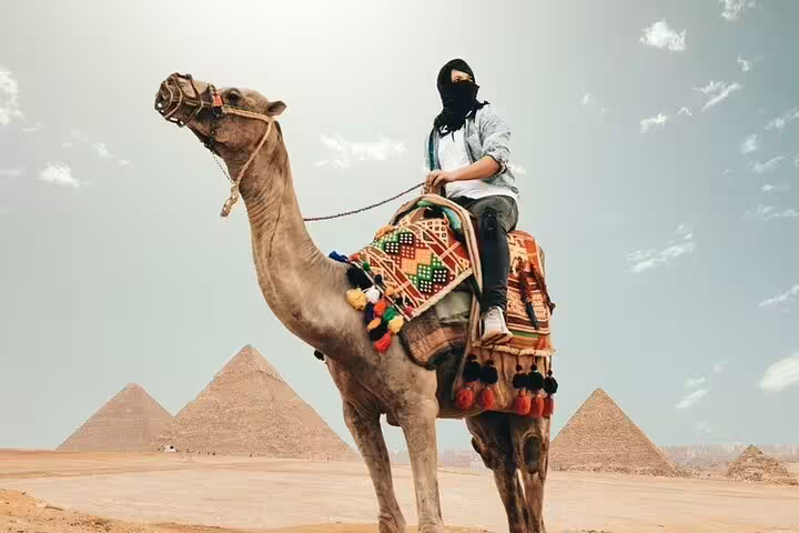 Camel ride photo stop at Giza Pyramids on private tour from Port Said shore excursion to Cairo museums