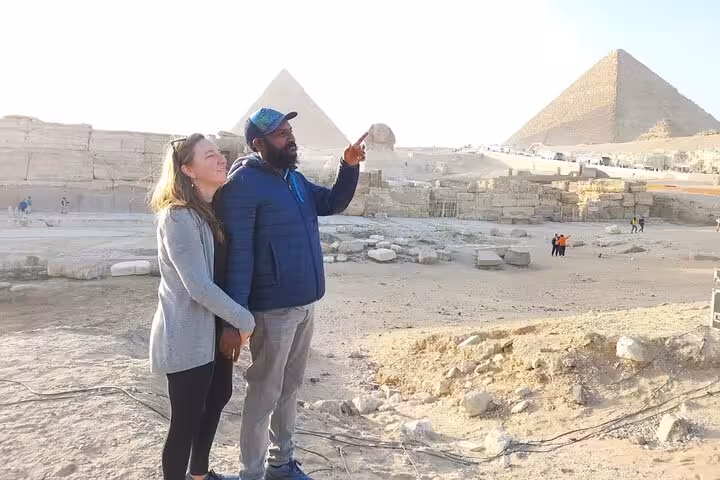 Private guide showing guests the Giza Pyramids viewpoint on a Cairo tour with Citadel, Khan el-Khalili bazaar and Nile felucca