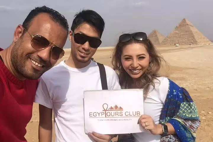 Travelers with guide at Giza Pyramids during private day tour from Alexandria to Cairo and museum