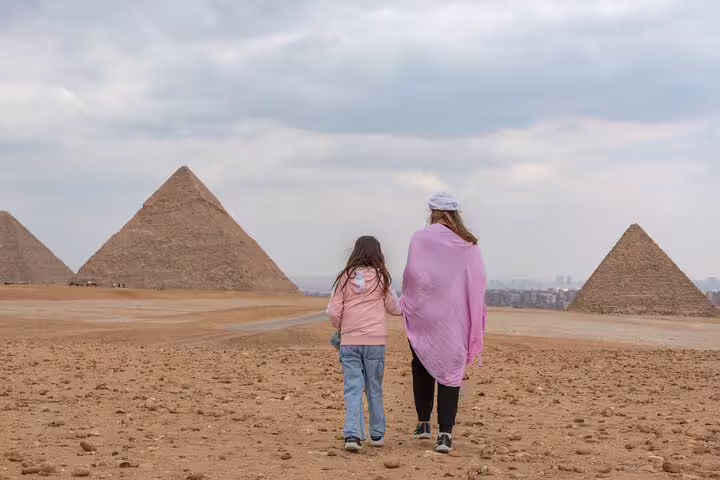 Visitors walking toward the Giza Pyramids on a private El-Sokhna Port shore excursion with guide