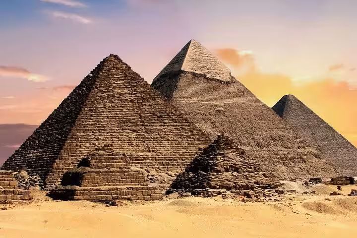 Giza pyramids in the desert at golden hour on a full-day guided tour from Sharm El Sheikh by bus with lunch