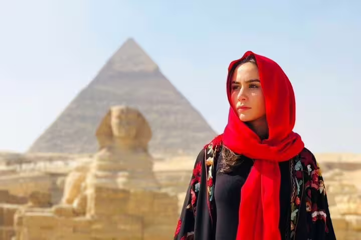 Traveler in red scarf at Great Sphinx and Giza Pyramids on Alexandria Port shore excursion to Cairo