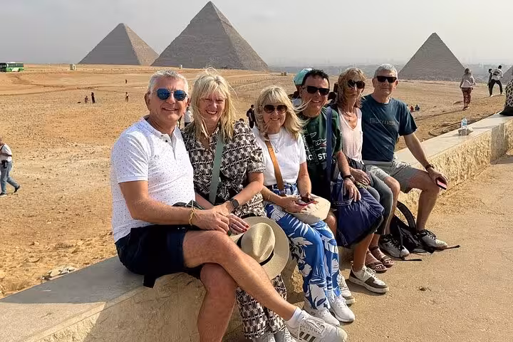 Tour group photo at Giza Plateau with the Great Pyramids behind, half-day Giza pyramids tour with lunch