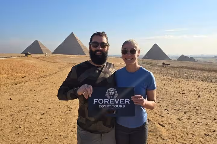 Guests pose at the Giza Pyramids with private guide, highlight photo for Cairo day tour and museum visit