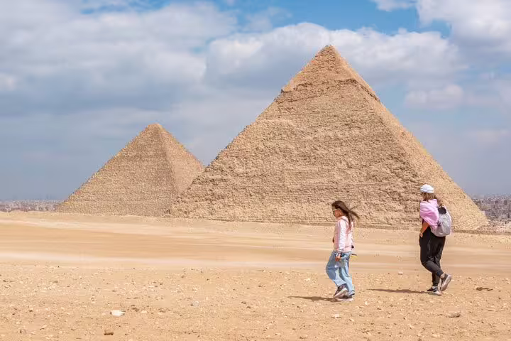 Travelers walking by the Great Pyramids of Giza on a private shore excursion from El-Sokhna Port