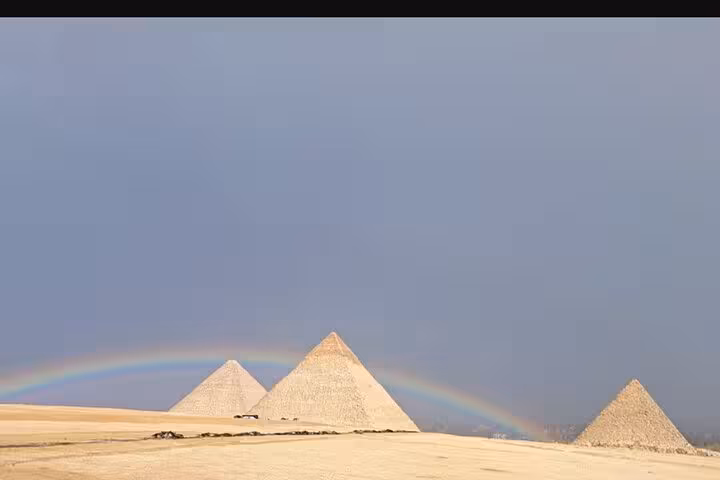 Giza pyramids under a rainbow over the desert, highlight of Saqqara & Giza Pyramids tour with camel ride