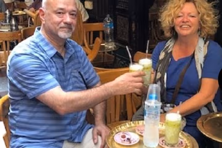 Guests enjoying Egyptian drinks at a local cafe during a VIP all-inclusive Giza, Sakkara and camel ride tour