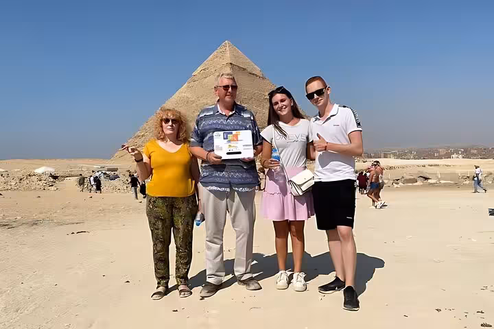 Group photo at Giza Plateau with pyramid backdrop, using skip-the-line entry ticket for fast site access