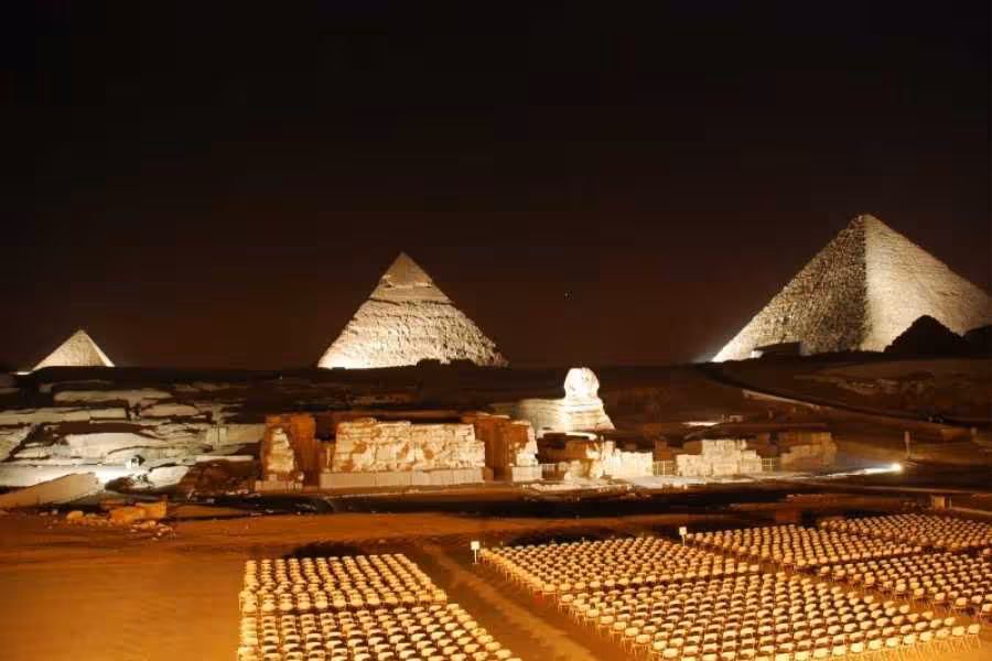 Giza Pyramids Sound and Light Show seating area with Sphinx and pyramids lit at night, Cairo tour