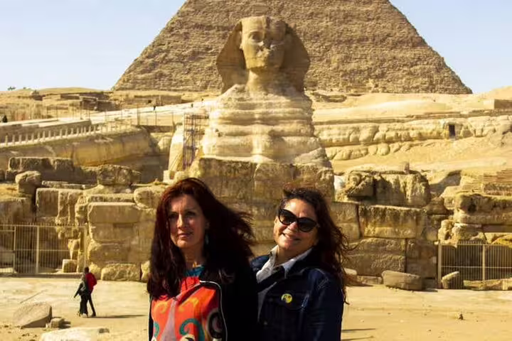 Travelers posing by the Great Sphinx and Pyramid of Khafre on Alexandria Port private day trip to Giza